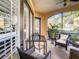 Relaxing screened porch with wicker furniture and glass table at 513 Mirasol Cir # 101, Celebration, FL 34747