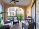 Relaxing screened porch with wicker chairs and small table at 513 Mirasol Cir # 101, Celebration, FL 34747