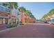 Brick-paved street with shops and palm trees at 513 Mirasol Cir # 101, Celebration, FL 34747