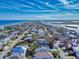 Aerial view of coastal neighborhood, showcasing ocean and inlet views at 6353 River Rd, New Smyrna Beach, FL 32169