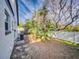Landscaped backyard with tropical plants and a white fence at 6353 River Rd, New Smyrna Beach, FL 32169