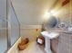Bathroom with pedestal sink, shower, and tile at 6353 River Rd, New Smyrna Beach, FL 32169