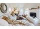 Open living room with a fireplace and comfy seating area at 6353 River Rd, New Smyrna Beach, FL 32169