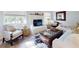 Cozy living room featuring a fireplace, comfy seating, and large windows at 6353 River Rd, New Smyrna Beach, FL 32169