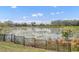 Peaceful lake view from backyard, featuring a black metal fence at 7833 Oak Reflection Loop, Davenport, FL 33837