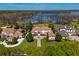 Luxury estate home on a lake with beautifully landscaped grounds and neighboring homes at 9343 Tibet Pointe Cir, Windermere, FL 34786