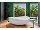 Luxurious bathroom with freestanding tub, and views of lush greenery at 9343 Tibet Pointe Cir, Windermere, FL 34786