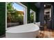 Relaxing bathroom with a large soaking tub and two windows overlooking garden at 9343 Tibet Pointe Cir, Windermere, FL 34786