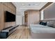 Modern bedroom with wood wall accents and large TV at 9343 Tibet Pointe Cir, Windermere, FL 34786