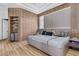 Modern bedroom with wood wall accents and large TV at 9343 Tibet Pointe Cir, Windermere, FL 34786