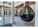 Relaxing courtyard with hanging chair and stone pathway at 9343 Tibet Pointe Cir, Windermere, FL 34786