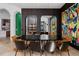 Elegant dining room showcasing a long black table, wine storage, and modern chairs at 9343 Tibet Pointe Cir, Windermere, FL 34786