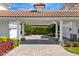 Elegant covered driveway with columns, landscaping, and access to garage at 9343 Tibet Pointe Cir, Windermere, FL 34786