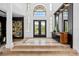 Two-story foyer with elegant tile floors and statement art at 9343 Tibet Pointe Cir, Windermere, FL 34786