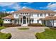 Stunning two-story home with a circular driveway and beautifully landscaped front yard at 9343 Tibet Pointe Cir, Windermere, FL 34786