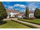 Elegant home with a porte cochere, tile roof, and meticulously maintained landscaping at 9343 Tibet Pointe Cir, Windermere, FL 34786