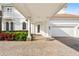Elegant home exterior with covered entry and paver driveway at 9343 Tibet Pointe Cir, Windermere, FL 34786