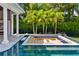 Expansive fire pit with pool and lush landscaping at 9343 Tibet Pointe Cir, Windermere, FL 34786