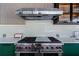 High-end stainless steel gas cooktop with red knobs at 9343 Tibet Pointe Cir, Windermere, FL 34786