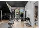 Modern home gym with various strength and cardio equipment at 9343 Tibet Pointe Cir, Windermere, FL 34786