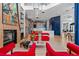 Living room with fireplace and red velvet armchairs at 9343 Tibet Pointe Cir, Windermere, FL 34786