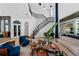 Two-story living room with a stunning staircase and stylish decor at 9343 Tibet Pointe Cir, Windermere, FL 34786