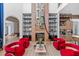 Living area with fireplace, red armchairs, and high ceilings at 9343 Tibet Pointe Cir, Windermere, FL 34786