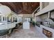 Outdoor kitchen with a pizza oven and stainless steel grill at 9343 Tibet Pointe Cir, Windermere, FL 34786