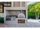 Built-in pizza oven and grill in outdoor kitchen at 9343 Tibet Pointe Cir, Windermere, FL 34786