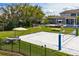 Sand volleyball court with seating and lake view at 9343 Tibet Pointe Cir, Windermere, FL 34786