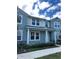 Two-story light teal home with white columns and landscaping at 10215 Highline Crest St, Orlando, FL 32832