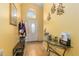 Bright entryway with wood floors, coat rack, and glass-top console table at 12618 Lynchburg Ct, Orlando, FL 32837