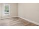 Bright bedroom with wood-look floors and large window at 135 S Arlington Ave, Deland, FL 32724