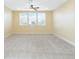 Spacious bedroom with three windows and ceiling fan at 15870 Citrus Grove Loop, Winter Garden, FL 34787