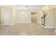 Open concept living area with tile floors, a chandelier, and a staircase at 15870 Citrus Grove Loop, Winter Garden, FL 34787