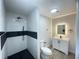 Modern bathroom with walk-in shower and floating vanity at 1625 Normandy Way, Leesburg, FL 34748