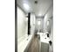 Modern bathroom with white subway tile and black accents at 1625 Normandy Way, Leesburg, FL 34748
