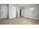Bedroom with large closet and wood-look floors at 1625 Normandy Way, Leesburg, FL 34748