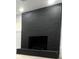 Modern black brick fireplace with a simple design at 1625 Normandy Way, Leesburg, FL 34748