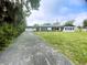 Charming ranch house with a large yard and flagpole at 1625 Normandy Way, Leesburg, FL 34748