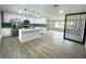 Modern kitchen with white cabinets, quartz countertops, and teal tile backsplash at 1625 Normandy Way, Leesburg, FL 34748