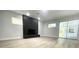 Living room with wood-look floors, fireplace, and sliding glass doors to backyard at 1625 Normandy Way, Leesburg, FL 34748