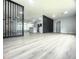 Open concept living space with modern wood-look floors and a stylish room divider at 1625 Normandy Way, Leesburg, FL 34748