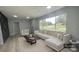 Living room boasts a comfy sectional sofa, large window, and modern coffee table at 1625 Normandy Way, Leesburg, FL 34748