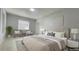 Main bedroom with plush bed and sitting area at 1625 Normandy Way, Leesburg, FL 34748