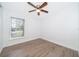 Simple bedroom with wood-look flooring and natural light from window at 2007 Dixie Belle Dr # 2007A, Orlando, FL 32812