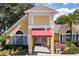 The community clubhouse features a welcoming entryway with a red awning and ample windows at 2007 Dixie Belle Dr # 2007A, Orlando, FL 32812
