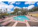 Community pool with lounge chairs and patio area at 2007 Dixie Belle Dr # 2007A, Orlando, FL 32812