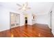 Bright living room with polished wood floors, ceiling fan, and French doors at 2007 Dixie Belle Dr # 2007A, Orlando, FL 32812