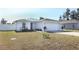 New single-story home with a partially covered roof, attached garage, fenced yard, and landscaping at 220 Hyacinth Ct, Poinciana, FL 34759